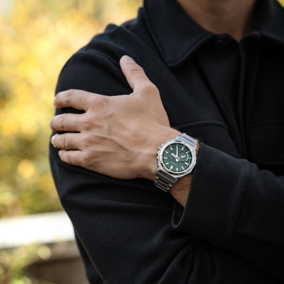 A man wearing a black jacket is wearing the GST-B1000D-3AER on his wrist
