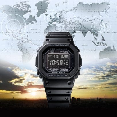 The GW-5000HS-1 from G-SHOCK in front of a landscape at sunrise. The world map is shown in the upper half.