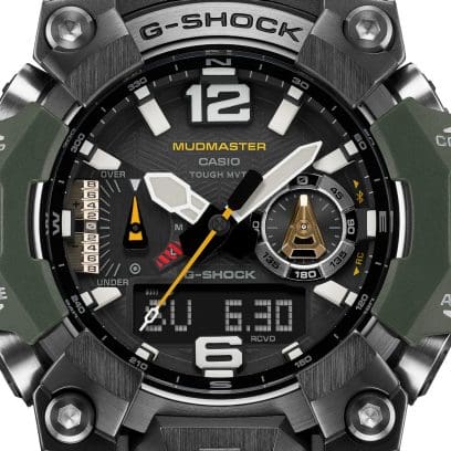 Close-up of the black, digital-analogue dial of the Mudmaster GWG-B1000-3A with its light-coloured hands and numerals, yellow accents and stainless steel case and dark green resin elements