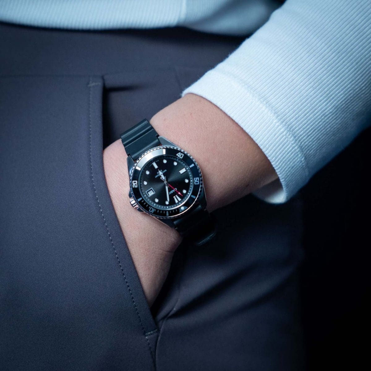 Close-up of the MDV-10-1A1V wristwatch with black strap and black case on the wrist of a woman with her hand in her trouser pocket.