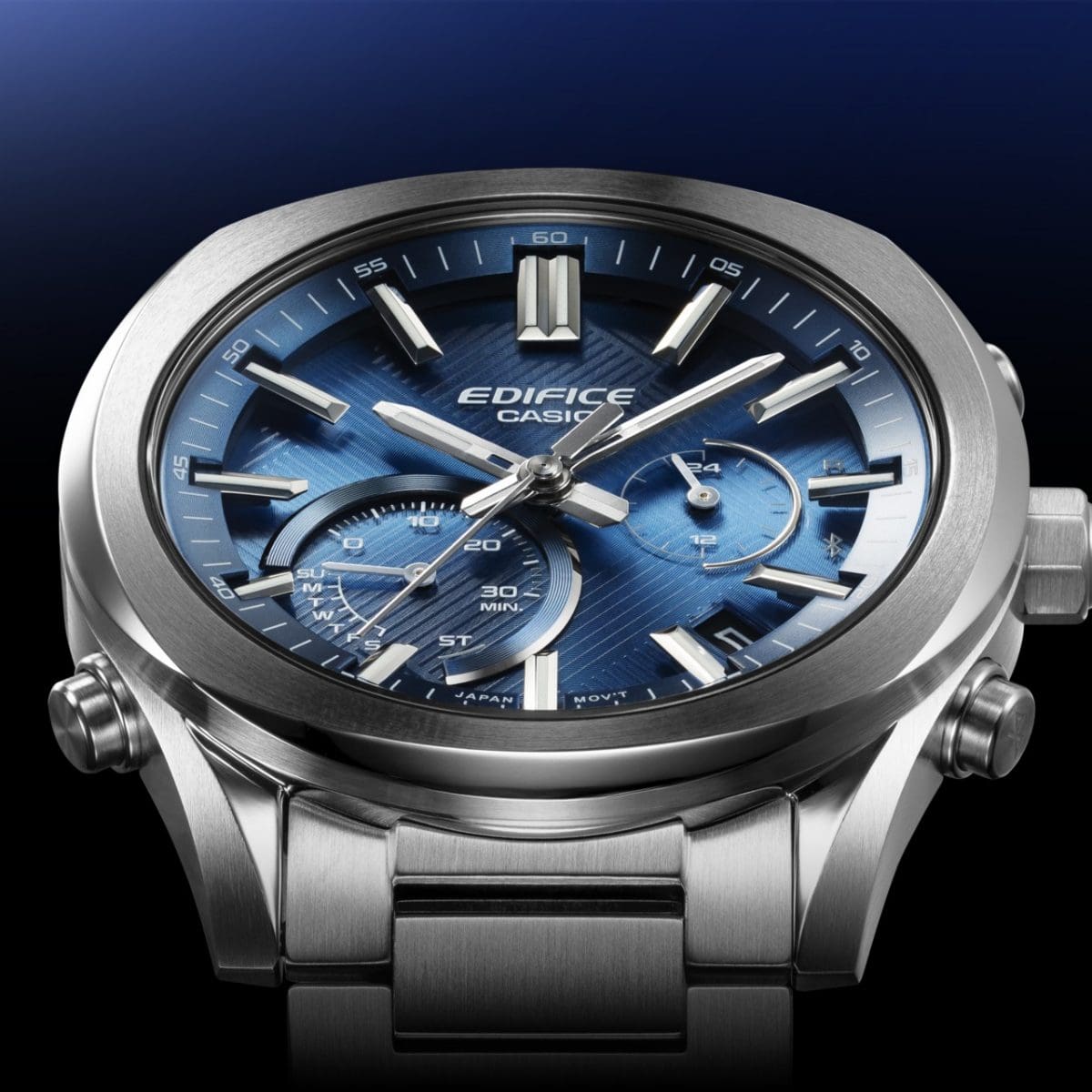 De indexen van het EDIFICE EQB-1300D-2AEF analoge horloge lijken boven het metallic, glinsterende oppervlak van de blauwe wijzerplaat te zweven.