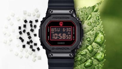 De GM-5600RH-1ER naast een groen blad met waterdruppels en zwart-witte kralen van het harsmateriaal