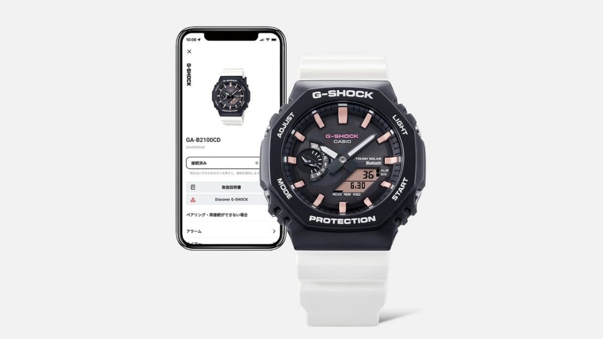 GA-B2100CD-1A7 ao lado de um smartphone no qual se pode ver a aplicação CASIO Watches.