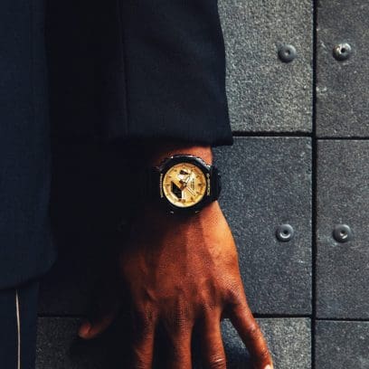 G-SHOCK Analog Digital GA-2100GB-1A Black Watch with Gold Dial on man's wrist denoting style