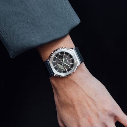 G-SHOCK GBM2100-1A stainless-steel watch on person’s wrist with their hand in their pocket denoting style