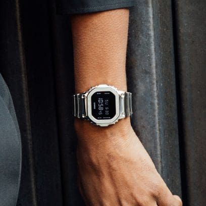 Close up of the G-SHOCK silver GM5600YM-8 watch with silicone watch band on a man’s wrist denoting style
