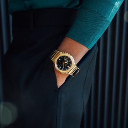 Close up of G-SHOCK GM2100YMG-9A gold watch on a man’s wrist denoting style