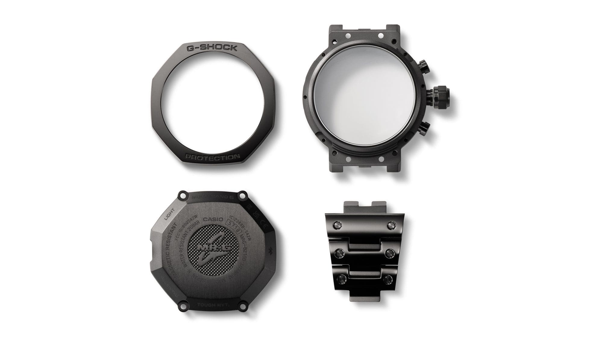 Vier Gehäusekomponenten der MRG-B2100B Armbanduhr nebeneinander