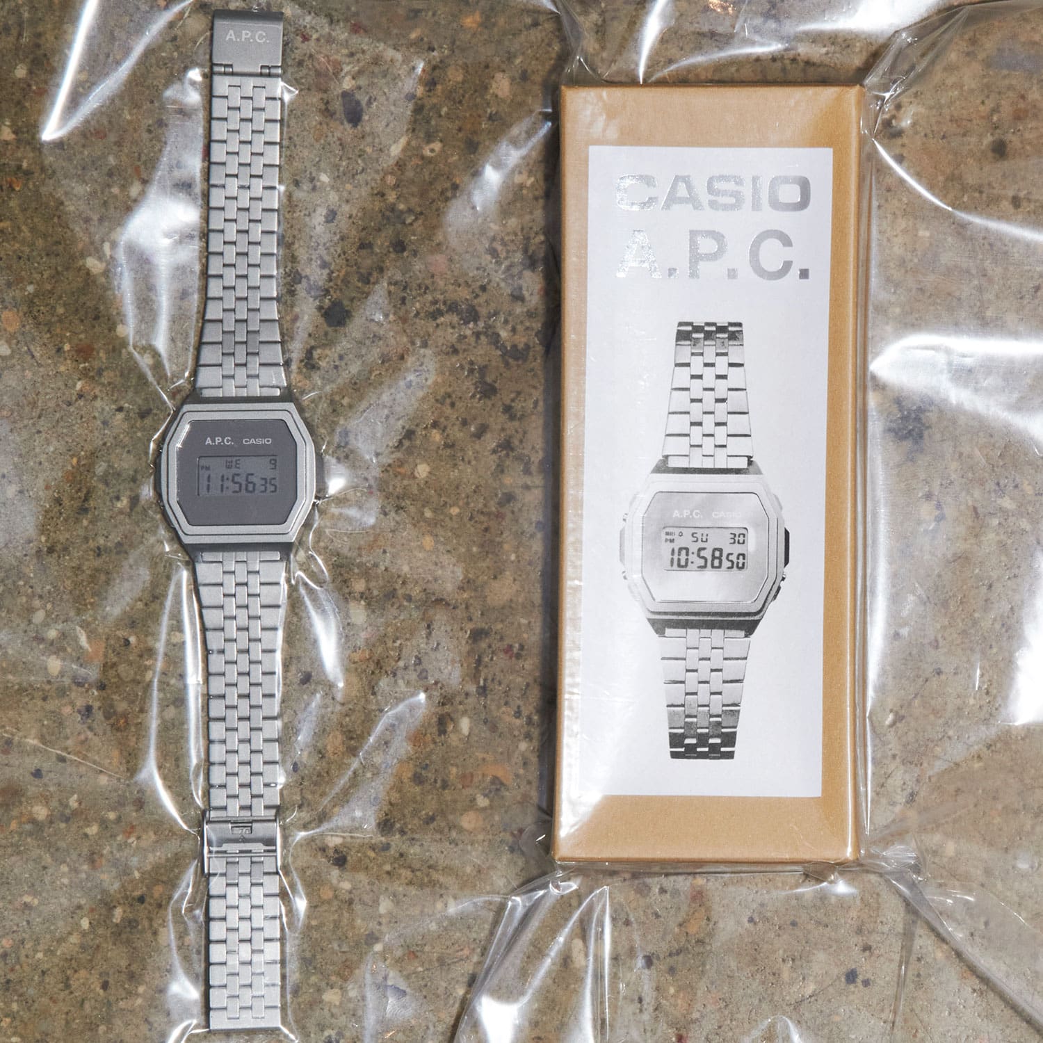 The silver-coloured A1000ACD-7 wristwatch lying next to the packaging box