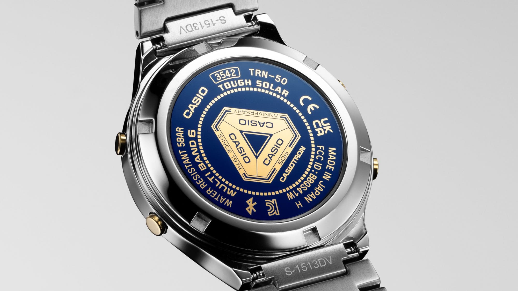 The blue case back of the TRN-50SS-2A wristwatch with gold lettering and anniversary logo