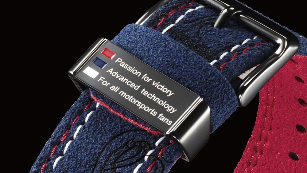 Strap loop of the wristband fastener with the inscription: ‘Passion for victory’, ‘Advanced technology’ and ‘For all motorsports fans’