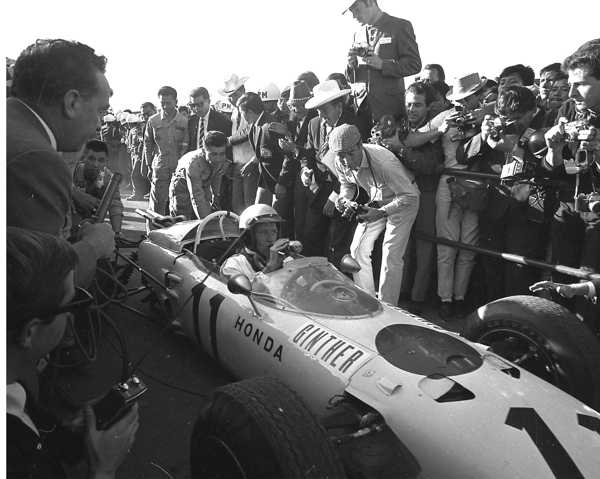 Photo of RA272 surrounded by reporters after winning its first victory.