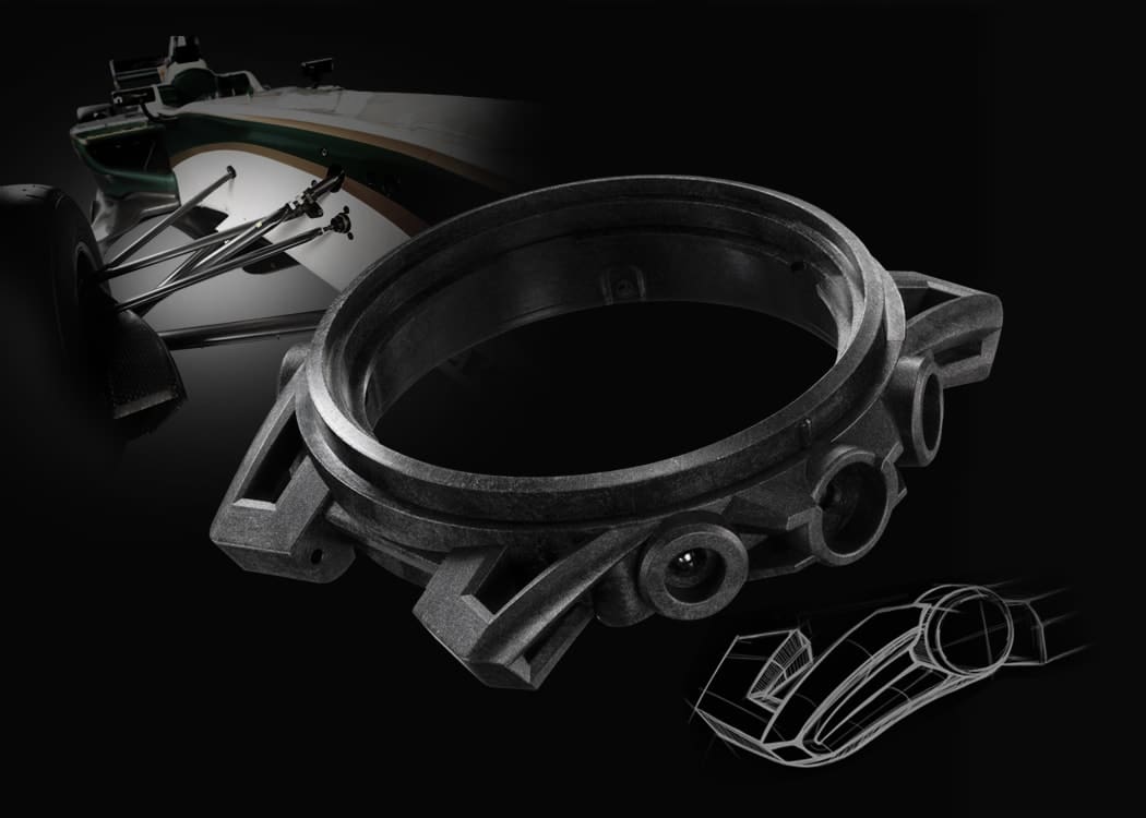Close-up of the case of a Casio Edifice ECB-40 wristwatch; the wheel suspension of a racing car can be seen in the background