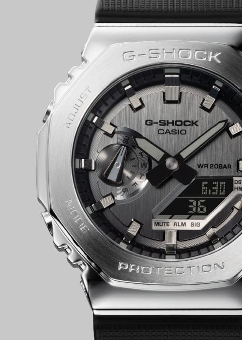 Close-up of the silver-coloured stainless steel case and dial of the Casio G-Shock GM-2100-1A hybrid watch