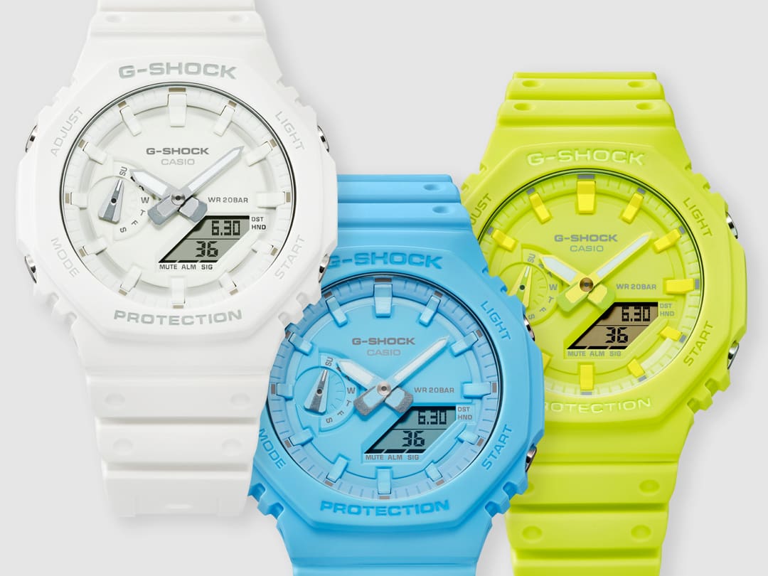 The white Casio G-Shock GA-2100-7A7 hybrid watch next to the turquoise-coloured GA-2100-2A2 and the yellow GA-2100-9A9
