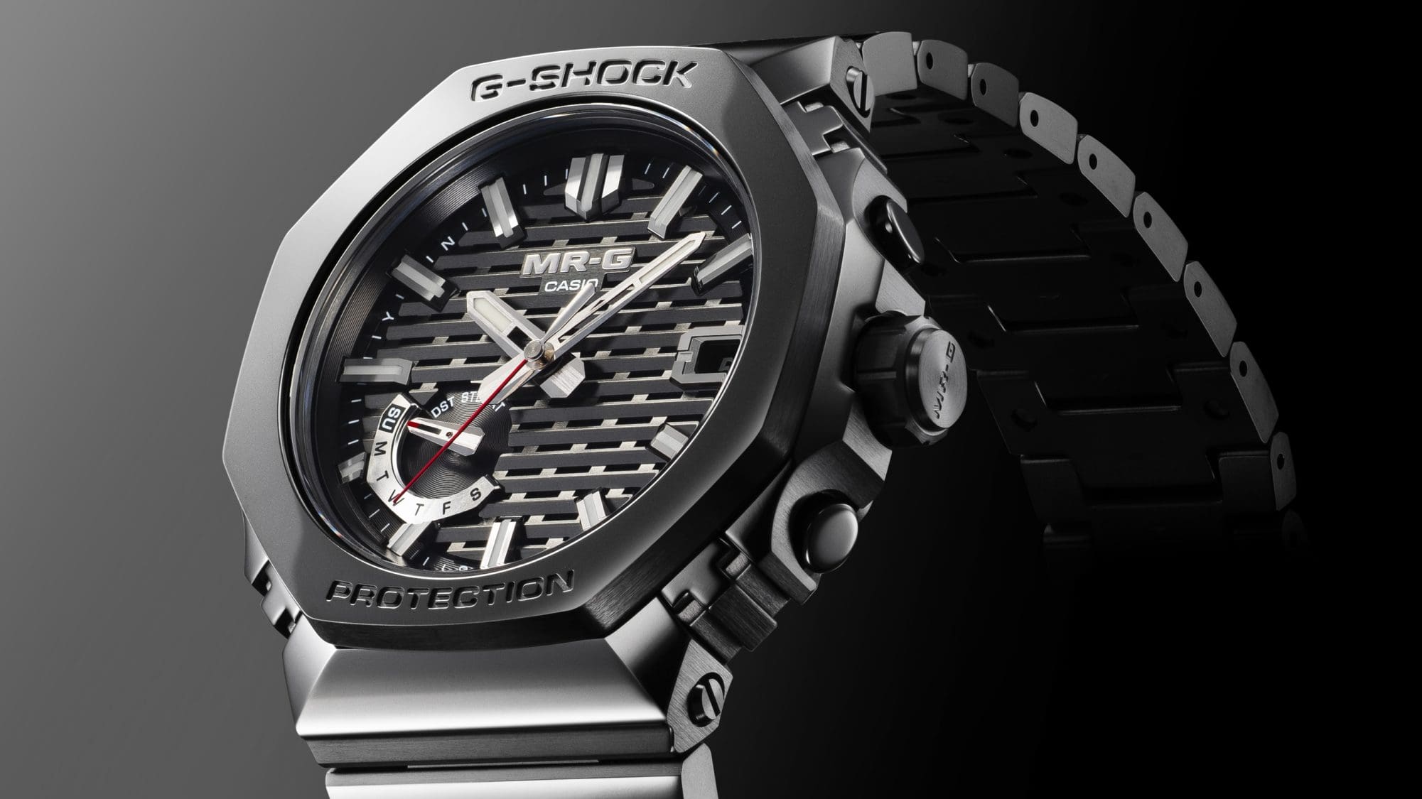 G-SHOCK MRG-B2100B wristwatch with black strap, black octagonal case and silver details on the dial.