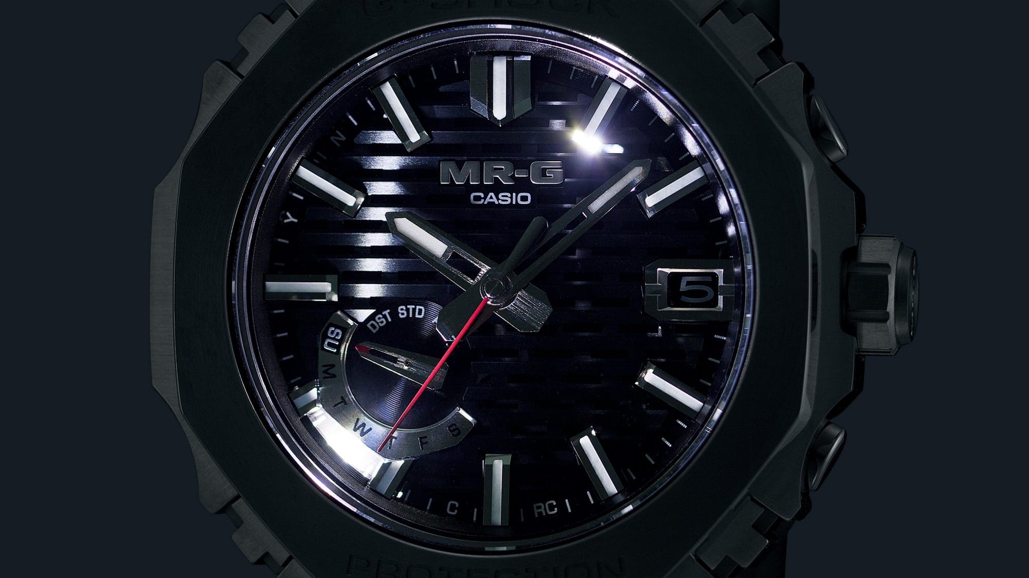 The illuminated display of an MRG-B2100D solar watch in the dark