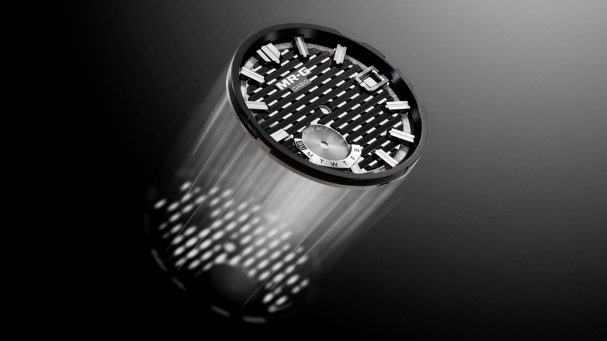 Light shines through the openings of the MRG-B2100D-1A dial on a dark background