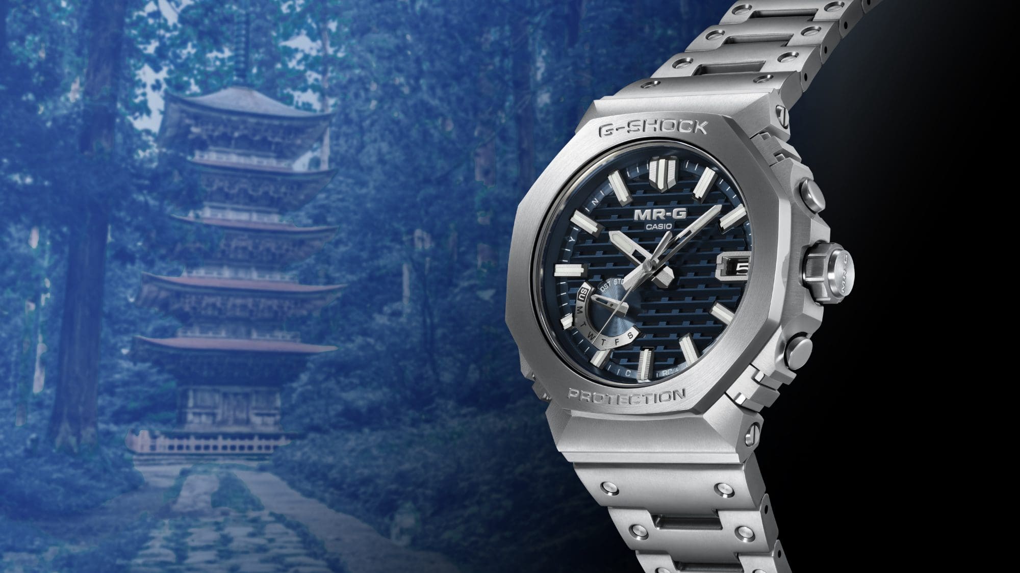 The MR-G-B2100D chronograph in front of a scene where morning mist envelops the mountain pagoda.