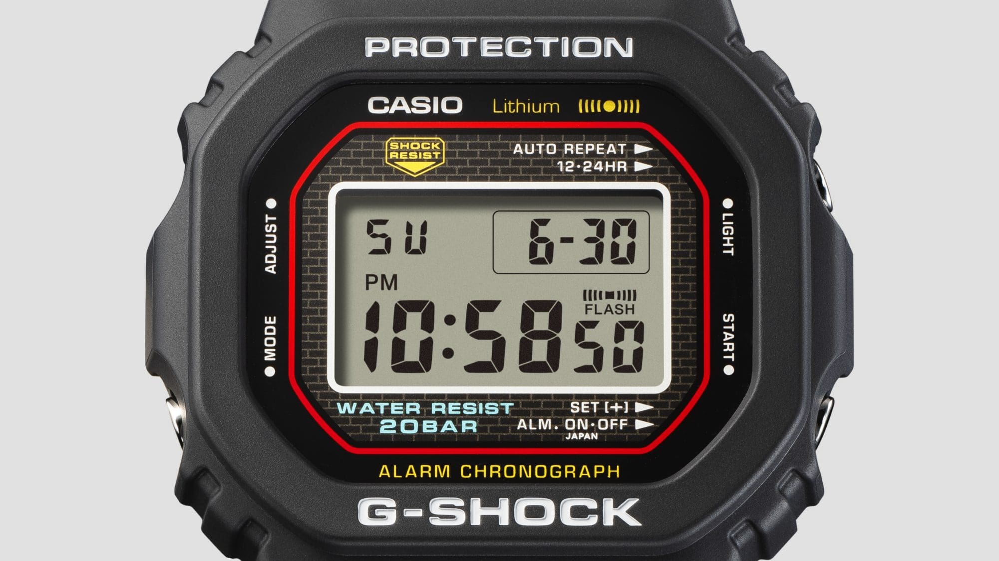 Close-up of the display of the anniversary watch with red, blue and yellow details and brick pattern