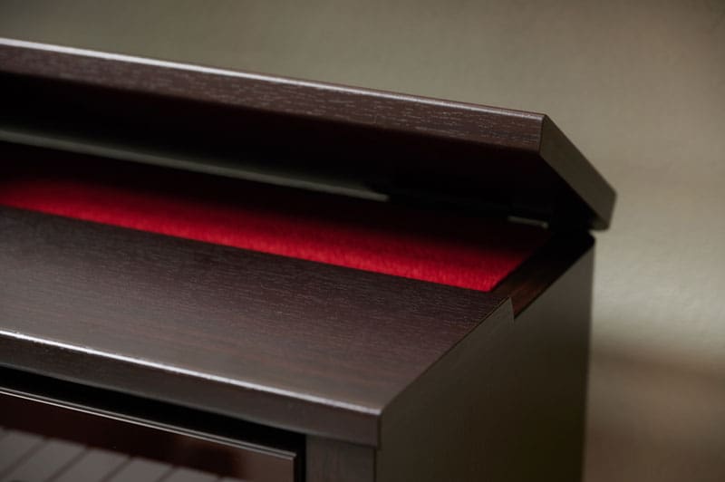 Close-up of the open top lid of the brown CELVIANO AP-550BN digital piano