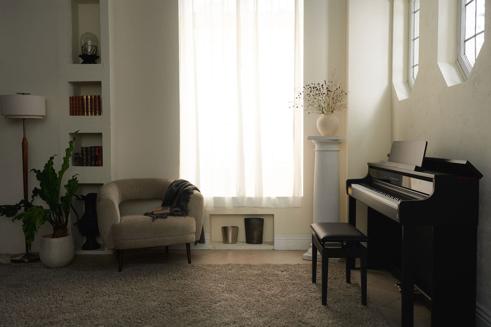 The black CASIO AP-750 digital piano stands at the wall of a bright, cosy living room