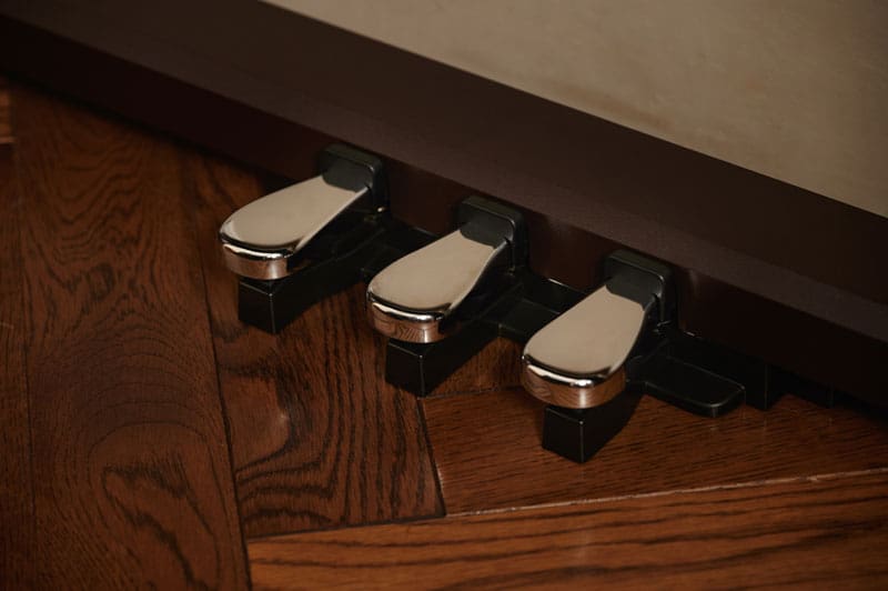 The three shiny pedals of a Celviano AP-S450 digital piano
