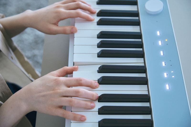 An image of a person's hand playing the piano