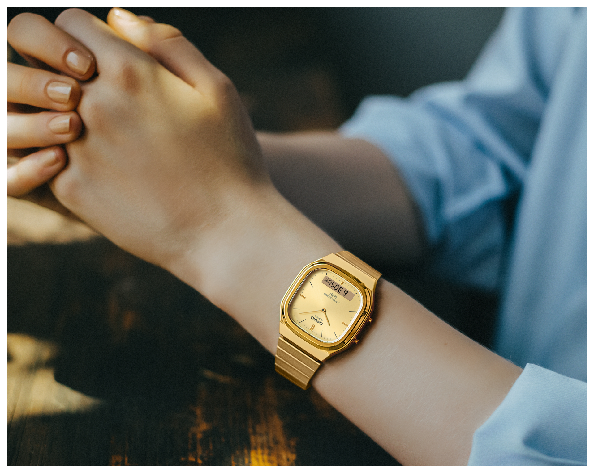 Image of the a woman holding their hands wearing AQ-240EG-9A. 