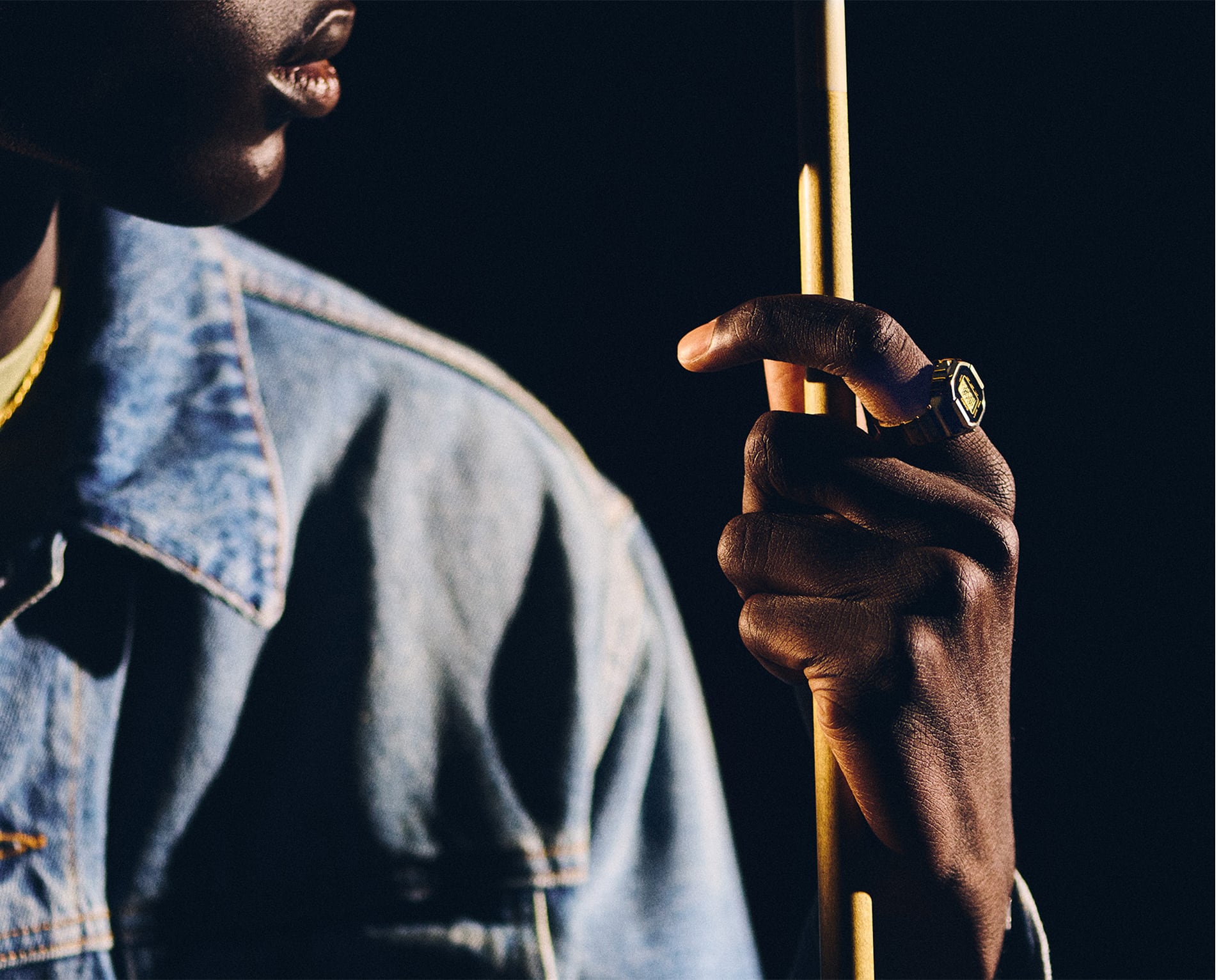Gold CRW001G-9 Casio ring watch on a man's finger while he holds a pool cue denoting style.