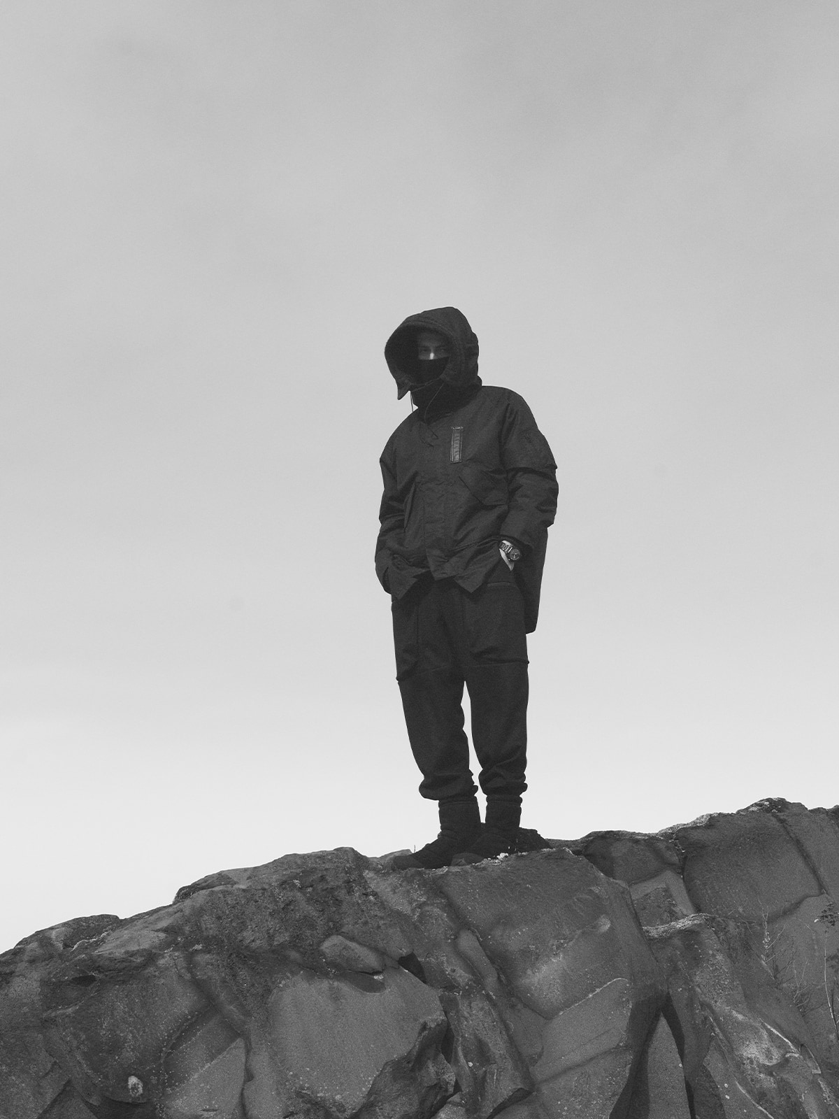 A monochrome photograph of a man standing while wearing the PRW-B1000WM-1