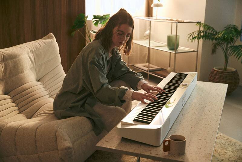 An image of a person playing the piano placed on a low table