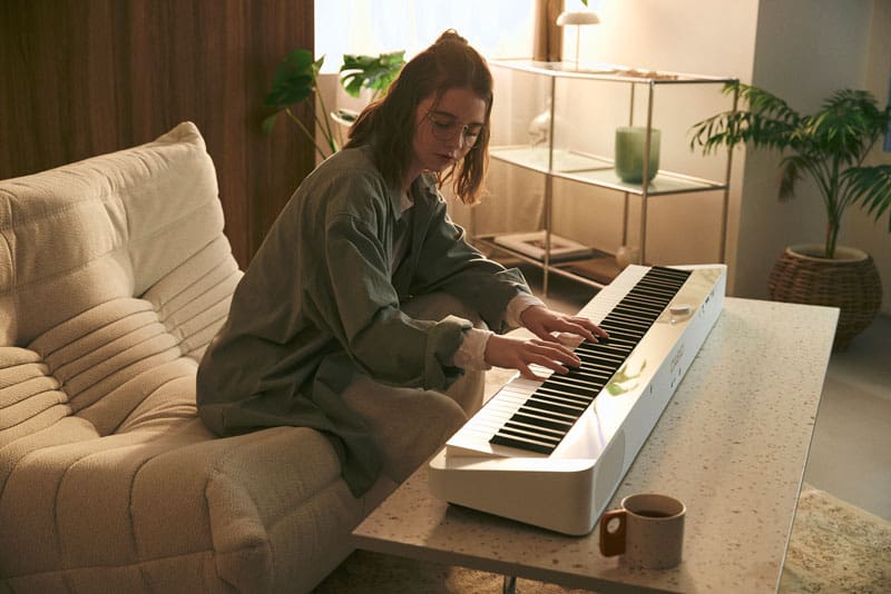 An image of a person playing the piano placed on a low table
