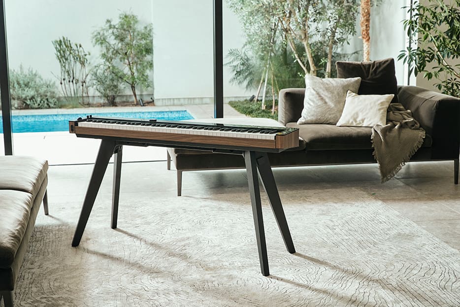 PX-S6000 on a stand in a living room with large windows PX-S6000 on a stand in a living room with large windows