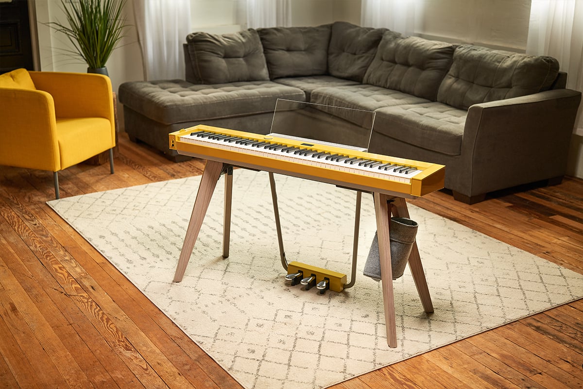 Yellow PX-S7000 keyboard on a stand in a room with wooden floor Yellow PX-S7000 keyboard on a stand in a room with wooden floor