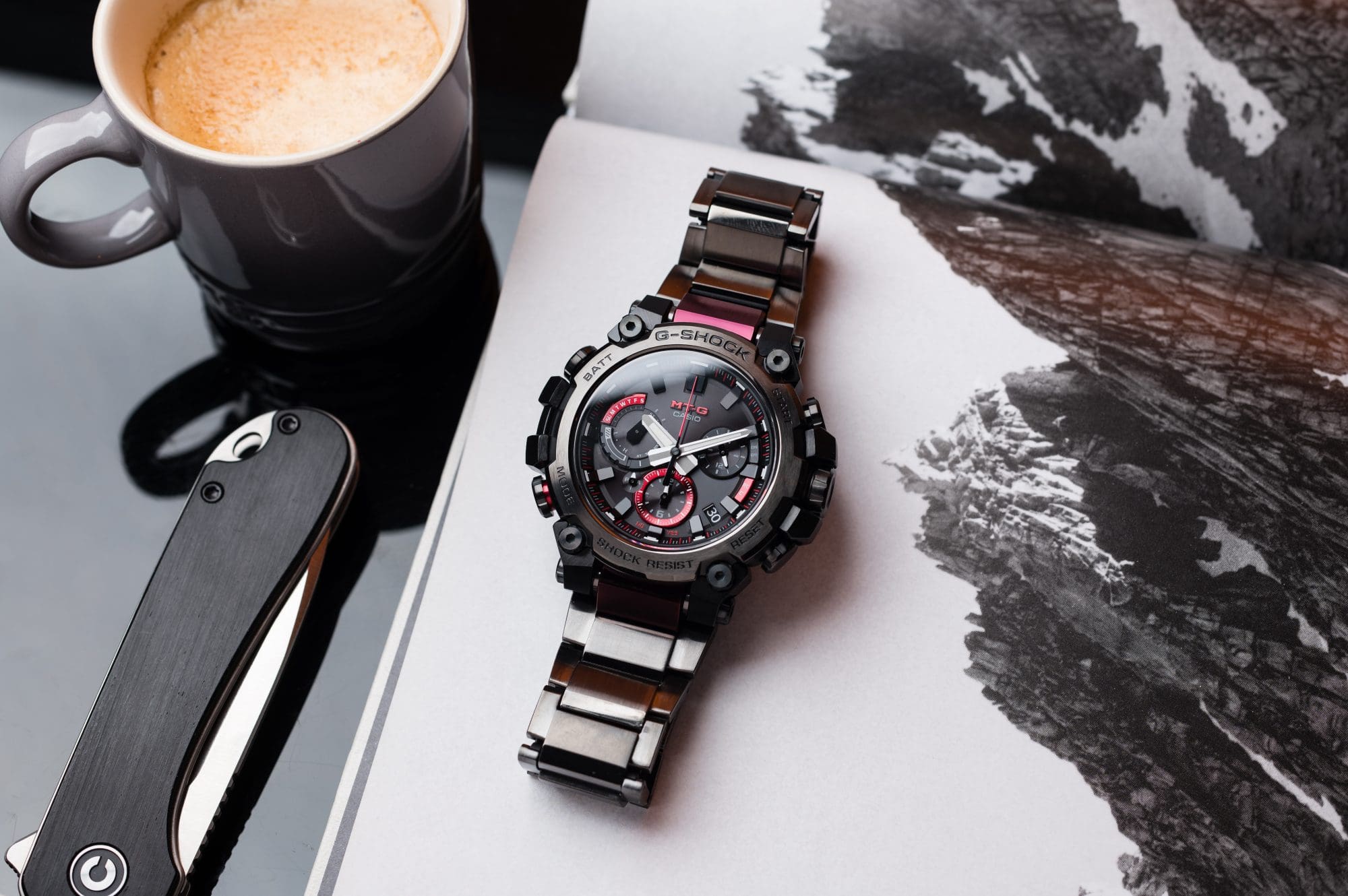 Coffee next to G-SHOCK MTG-B3000 watch