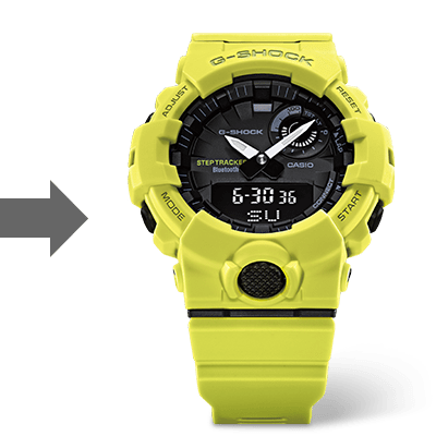 Une flèche grise pointe vers la droite en direction de la montre de course à pied Casio G-Squad GBA-800-9A jaune avec cadran noir.