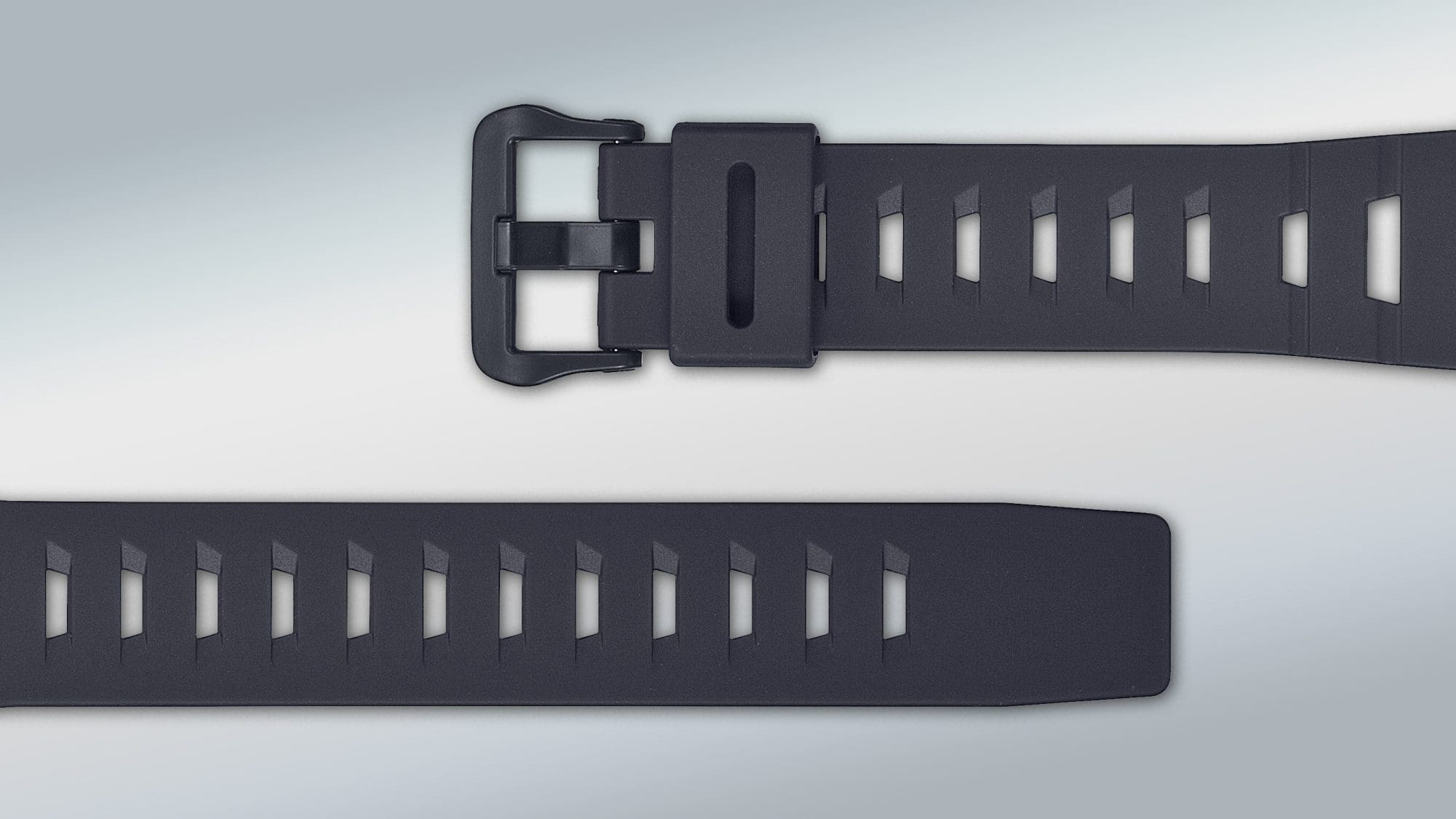 De zwarte horlogeband van het WS-B1000-1AV sporthorloge van flexibel materiaal met een rechthoekige gesp en veel gaten om de maat aan te passen