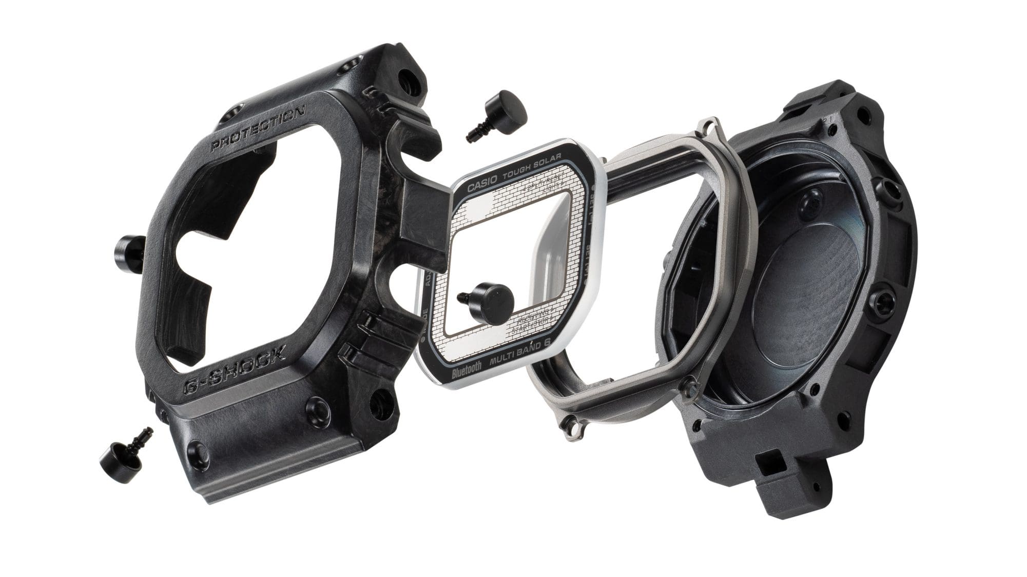 De individuele onderdelen van de monocoque kast: achterkant van de kast, binnenring, titanium knoppen, saffierglas en bezel
