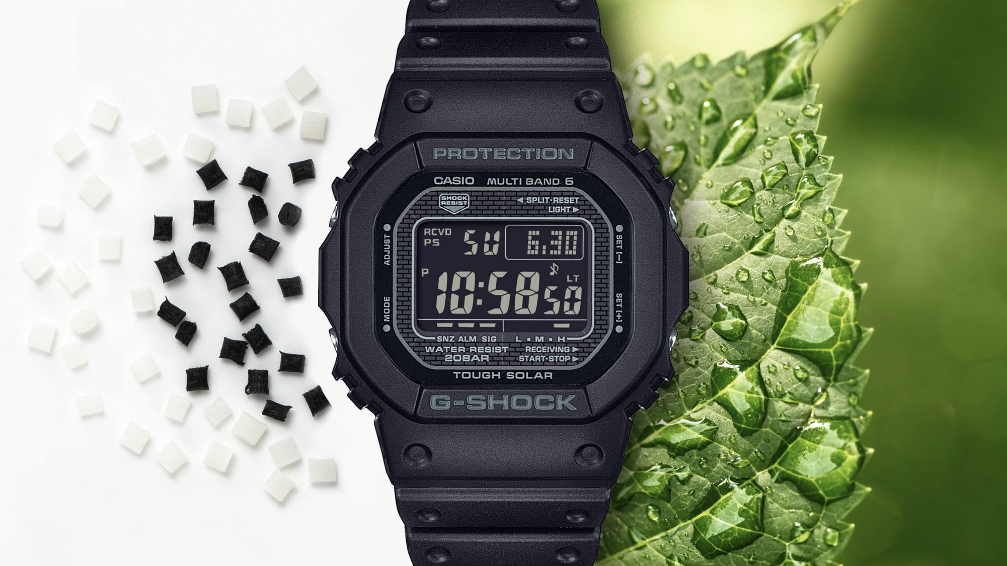 Het GW-5000 digitale horloge naast pellets van biohars en een groen blad