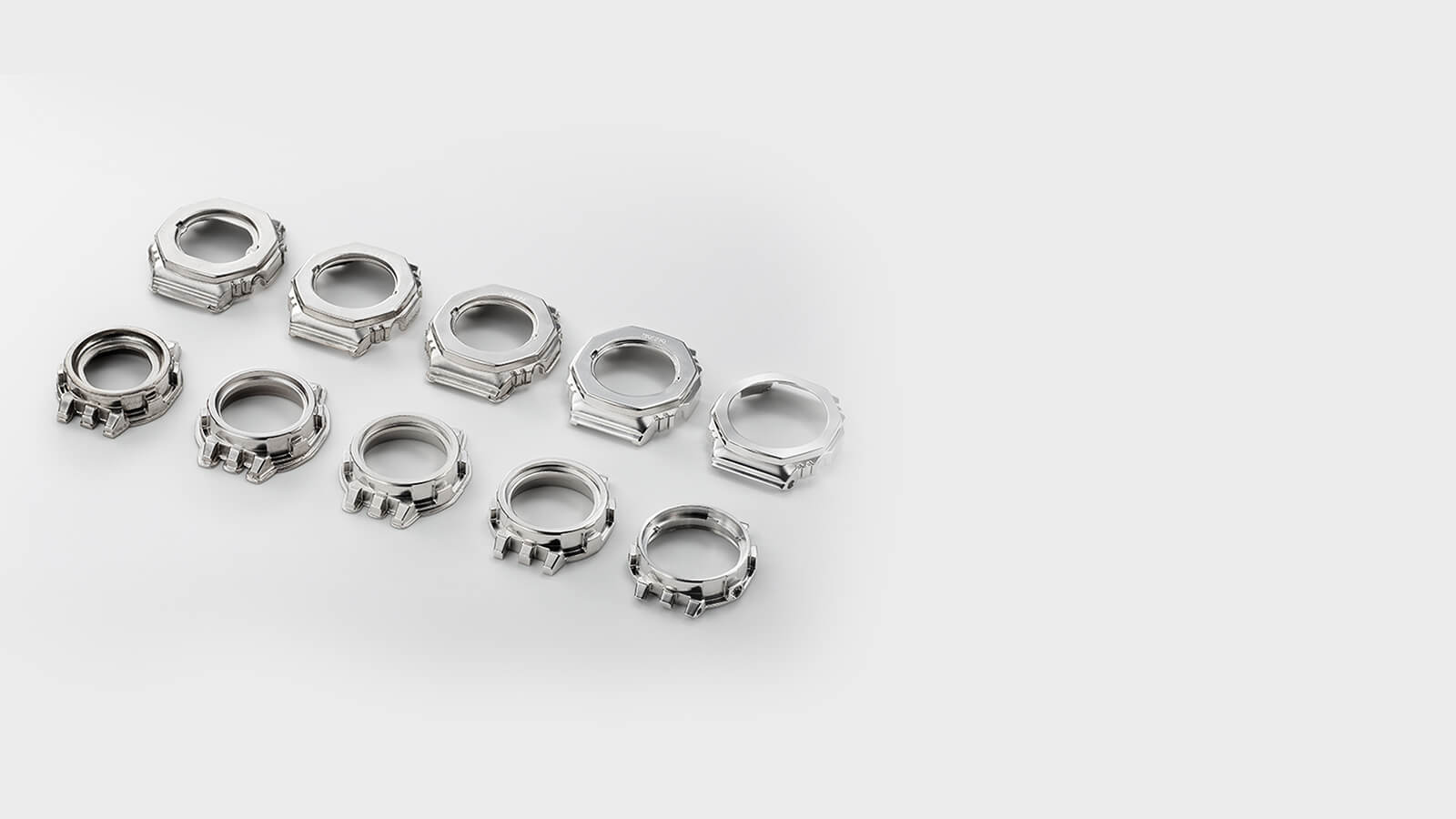   Tien zilverkleurige bezels in verschillende stadia van productie - van de lege tot de afgewerkte bezel