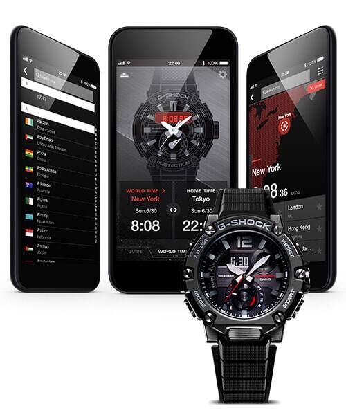 Drie smartphones met verschillende G-Shock Connected app schermen, met een zwart Casio G-Steel GST-B200 polshorloge ervoor.