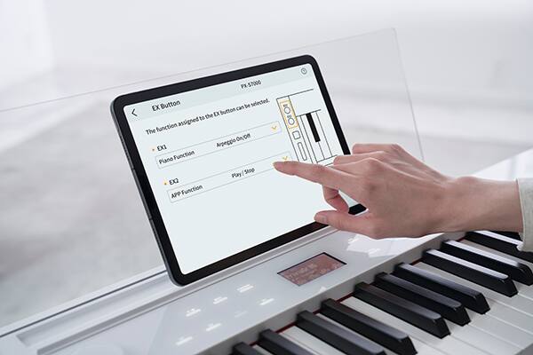 Een hand raakt een tablet aan in de transparante muziekhouder van de PX-S7000WE digitale piano om de “CASIO MUSIC SPACE” app te bedienen